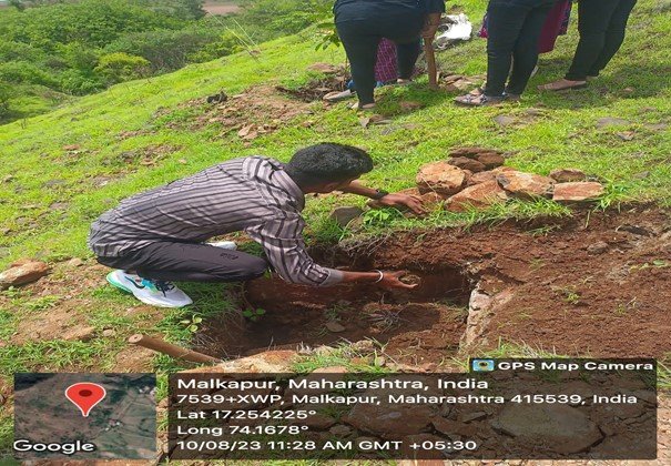 Digging the pits for plantation by the students